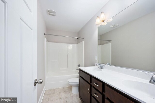 full bathroom with tile patterned flooring, vanity, shower / bath combination, and toilet