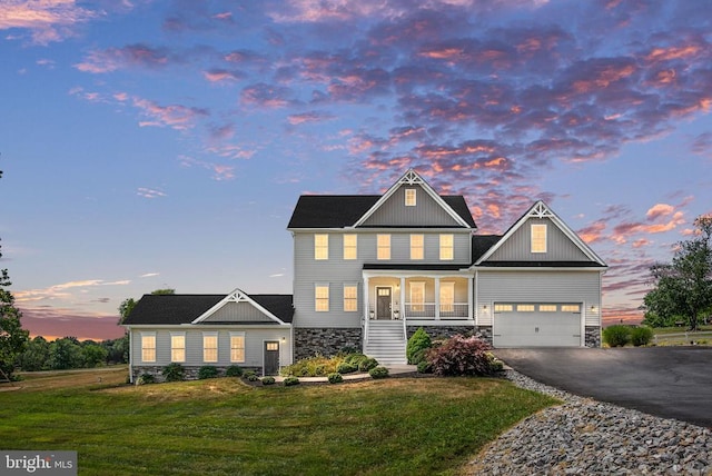 craftsman house featuring a garage and a yard