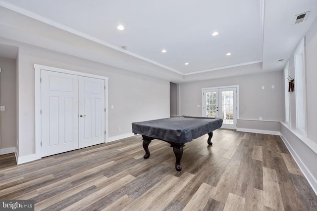 playroom with french doors, pool table, a tray ceiling, and light hardwood / wood-style floors