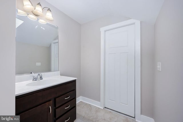 bathroom featuring vanity and vaulted ceiling