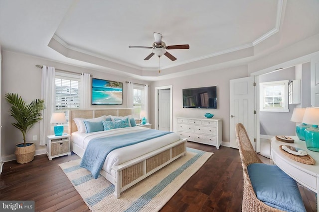 bedroom featuring a closet, dark hardwood / wood-style floors, and a tray ceiling