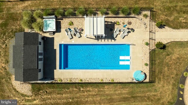 view of pool with a patio area and a lawn