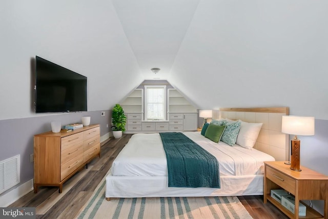 bedroom featuring vaulted ceiling and dark hardwood / wood-style floors