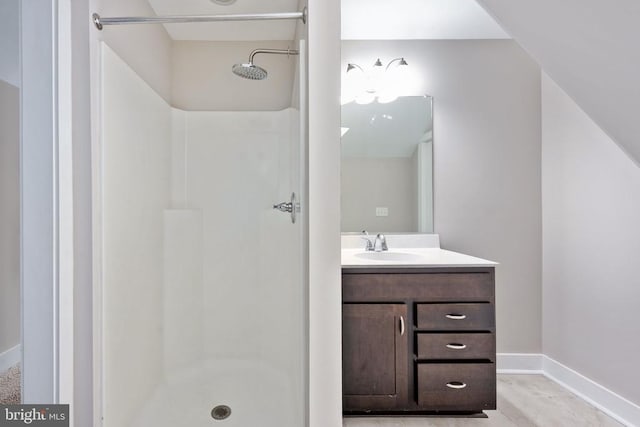 bathroom with vanity and a shower