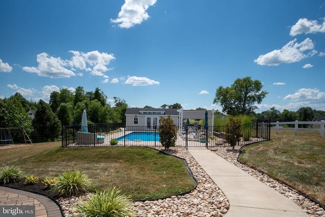 view of pool with a yard