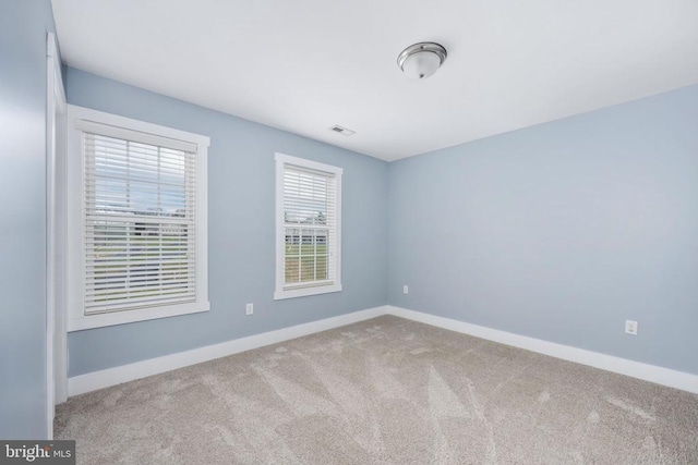 spare room with light colored carpet