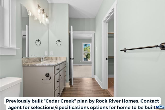 TBD Amelia Springs Road, Amelia, VA 23083 - bathroom featuring toilet, wood finished floors, vanity, a walk in closet, and baseboards