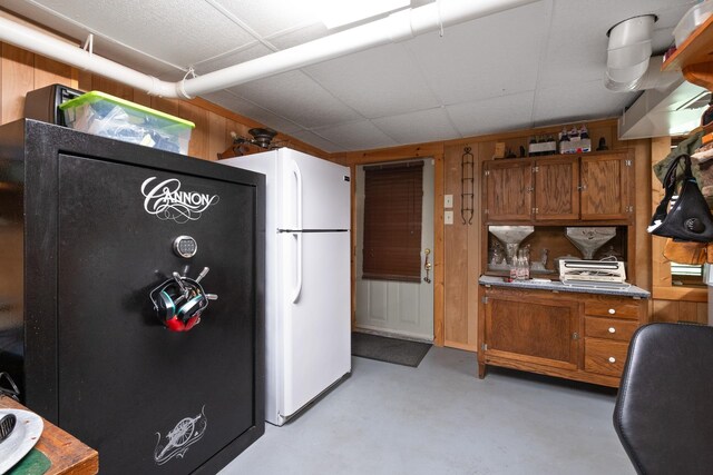 537 High Valley Dr N, Monterey, VA 24465 - kitchen featuring brown cabinets, freestanding refrigerator, finished concrete flooring, and wooden walls