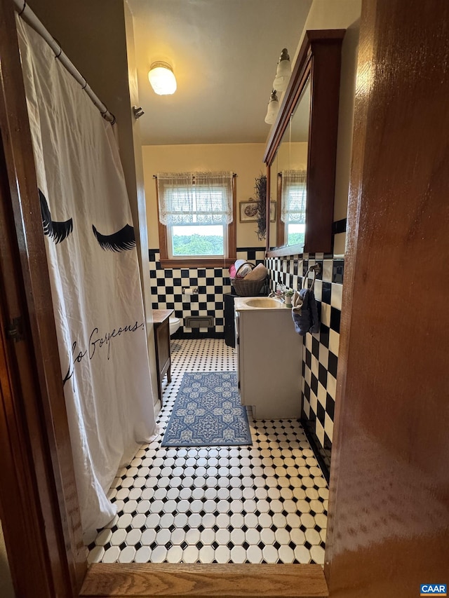 1820 Springhill Rd, Staunton, VA 24401 - bathroom featuring tile walls, vanity, a wainscoted wall, tile patterned flooring, and a shower with shower curtain