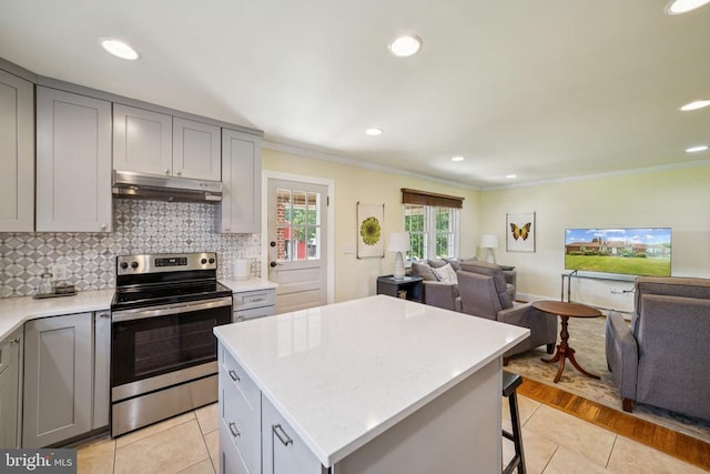 12014 Jefferson Hwy, Mineral, VA 23117 - kitchen with stainless steel electric range, under cabinet range hood, gray cabinetry, open floor plan, and ornamental molding