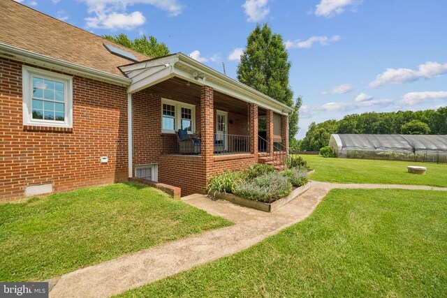 12014 Jefferson Hwy, Mineral, VA 23117 - view of exterior entry with a yard, brick siding, and a shingled roof