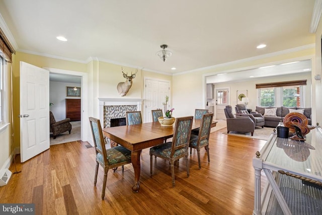 12014 Jefferson Hwy, Mineral, VA 23117 - dining area featuring light wood-style flooring, a fireplace, ornamental molding, and recessed lighting