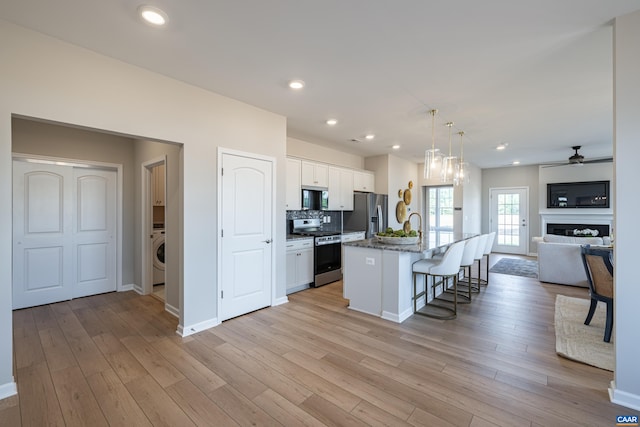 374 Bayberry Ln Unit F3C-20, Zion Crossroads, VA 22942 - kitchen featuring stainless steel appliances, open floor plan, a breakfast bar, white cabinets, and an island with sink