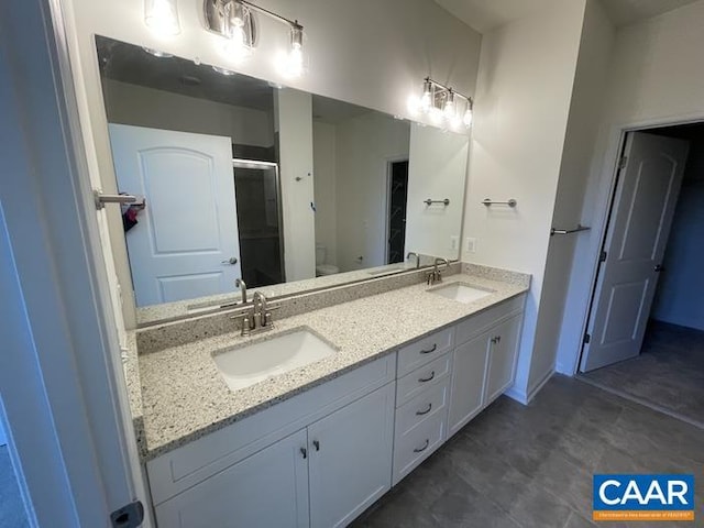 374 Bayberry Ln Unit F3C-20, Zion Crossroads, VA 22942 - bathroom featuring a shower stall, toilet, double vanity, and baseboards