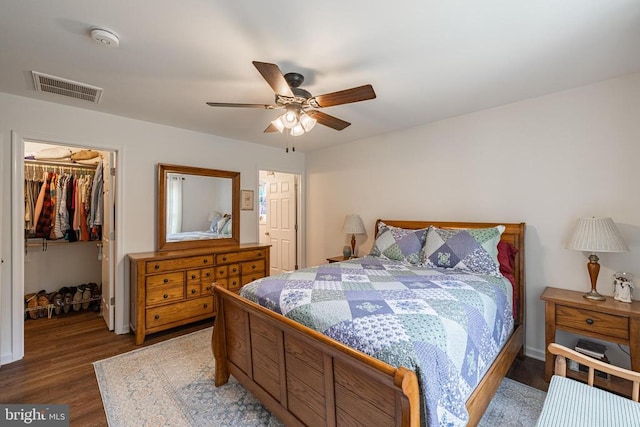 166 John Tucker Rd, Madison, VA 22727 - bedroom with a walk in closet, wood finished floors, a closet, and a ceiling fan