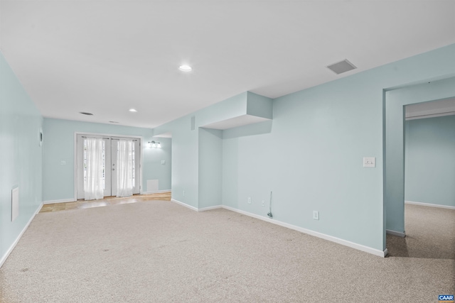 spare room featuring baseboards, recessed lighting, and carpet