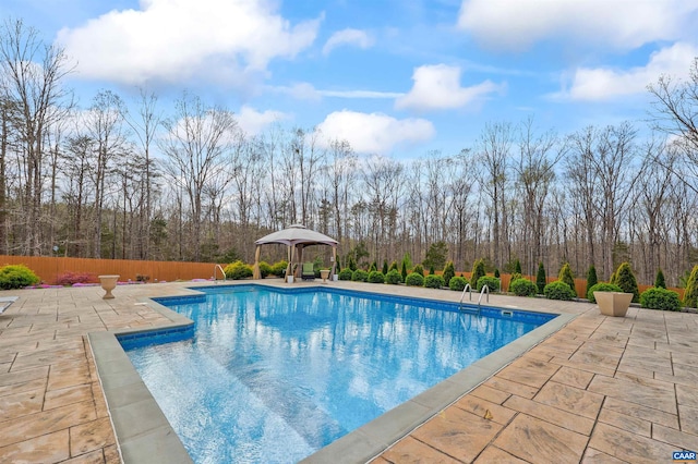 outdoor pool featuring a patio area and fence
