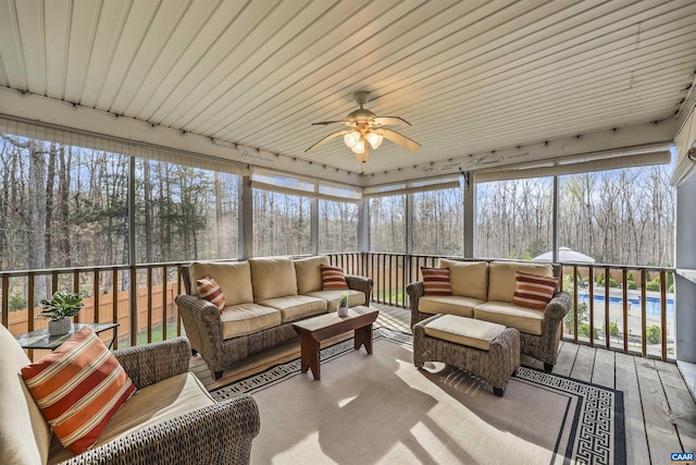 sunroom / solarium with ceiling fan and an outdoor living space