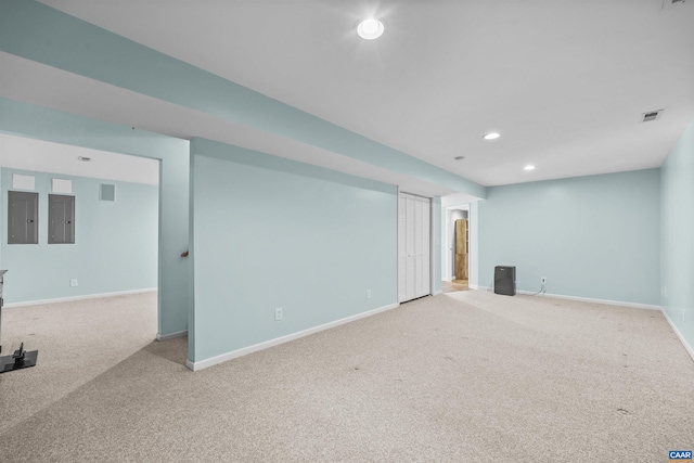 below grade area featuring electric panel, visible vents, recessed lighting, carpet flooring, and baseboards