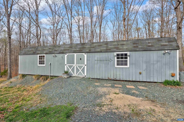 view of outdoor structure featuring central air condition unit and an outbuilding