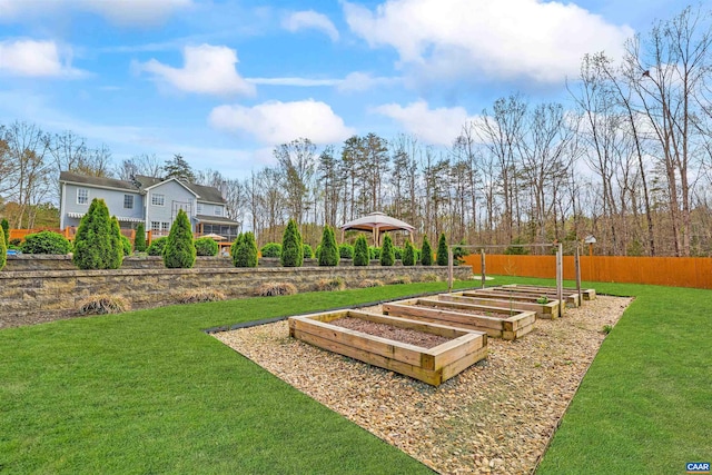 view of yard with fence and a garden