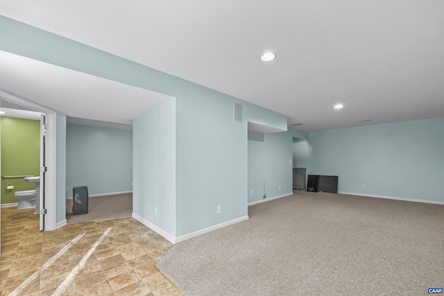 finished basement featuring baseboards, visible vents, and recessed lighting
