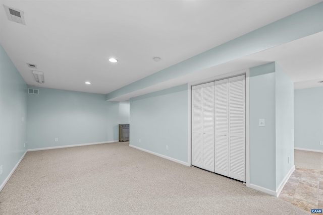 finished below grade area featuring carpet, baseboards, visible vents, and recessed lighting