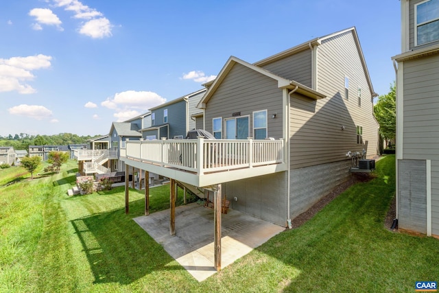 back of property featuring a patio, a wooden deck, a yard, central air condition unit, and a residential view