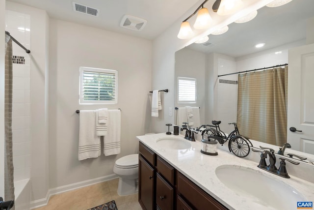 bathroom with toilet, tile patterned floors, baseboards, and double vanity