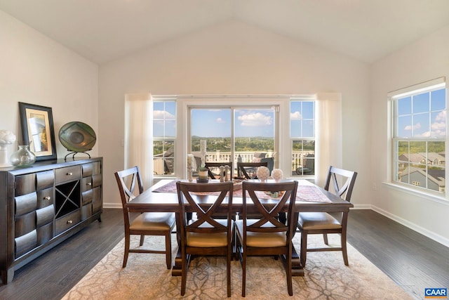 dining space featuring plenty of natural light, vaulted ceiling, baseboards, and dark wood-type flooring