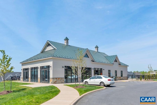 view of building exterior with uncovered parking