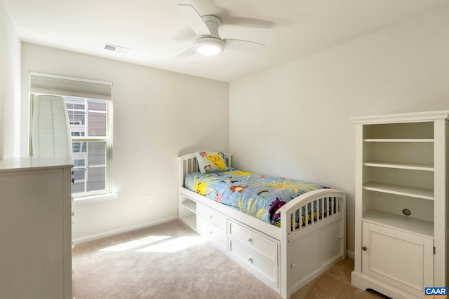 carpeted bedroom featuring baseboards and a ceiling fan