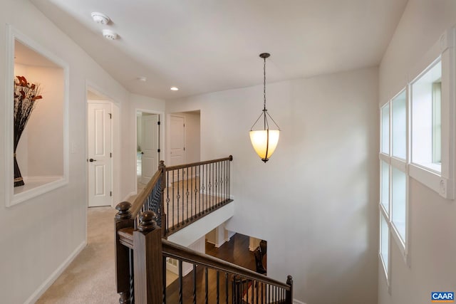 staircase featuring healthy amount of natural light, baseboards, carpet flooring, and recessed lighting