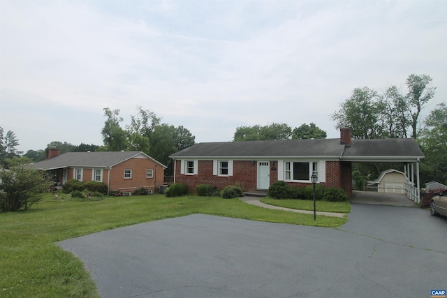 5649 Park Rd, Crozet, VA 22932 - ranch-style home featuring concrete driveway, a chimney, a front lawn, an attached carport, and an outdoor structure