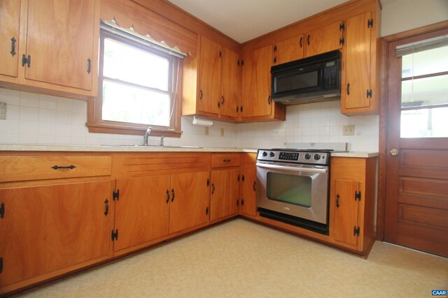 5649 Park Rd, Crozet, VA 22932 - kitchen with black microwave, electric range, a sink, light countertops, and decorative backsplash