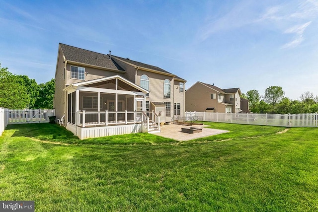 back of house with a patio, a sunroom, an outdoor fire pit, a fenced backyard, and a yard