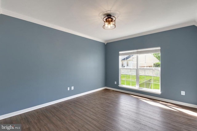 unfurnished room featuring baseboards, dark wood-style flooring, and ornamental molding