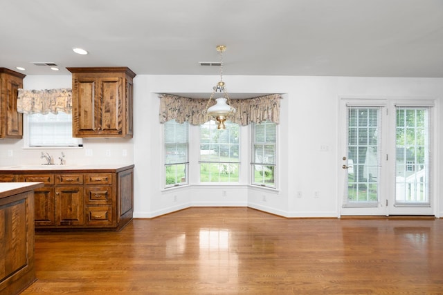 82 Pheasant Run, Waynesboro, VA 22980 - kitchen featuring brown cabinetry, wood finished floors, healthy amount of natural light, light countertops, and recessed lighting