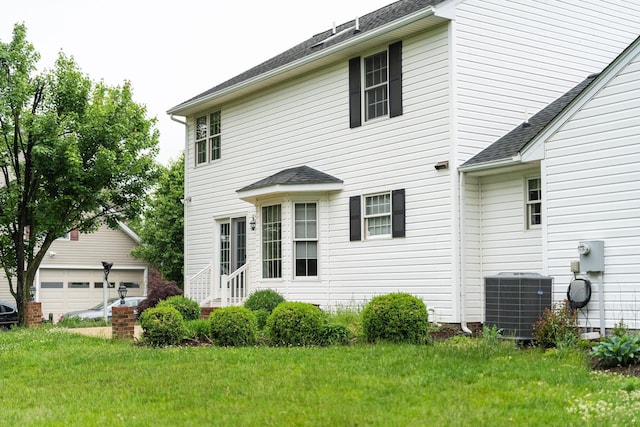 82 Pheasant Run, Waynesboro, VA 22980 - rear view of house with central air condition unit, an outbuilding, a yard, and a shingled roof
