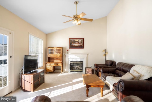 carpeted living area with a ceiling fan, a fireplace, and lofted ceiling