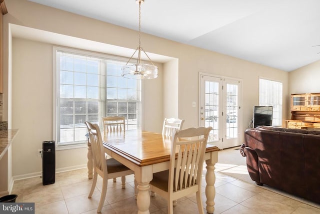 dining area featuring light tile patterned floors, baseboards, and a notable chandelier