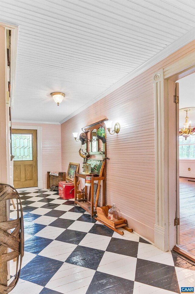 5722 James River Rd, Gladstone, VA 24553 - corridor featuring crown molding, a chandelier, tile patterned floors, and wooden walls