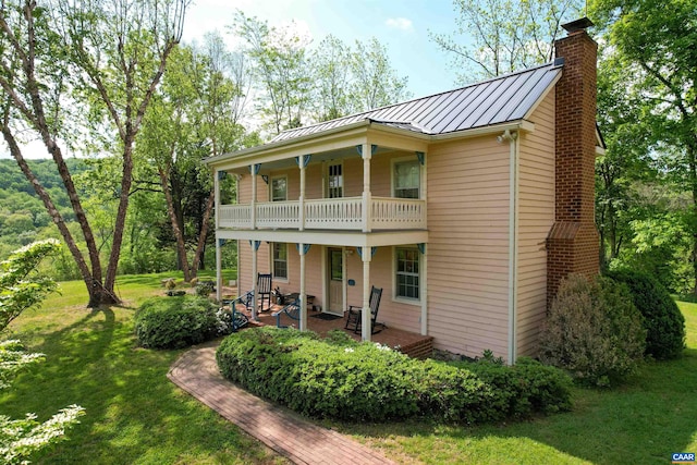 5722 James River Rd, Gladstone, VA 24553 - back of house featuring a standing seam roof, a balcony, a yard, a chimney, and metal roof