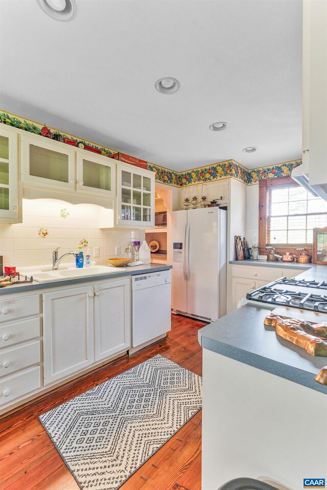 5722 James River Rd, Gladstone, VA 24553 - kitchen featuring white appliances, a sink, tasteful backsplash, dark wood finished floors, and glass insert cabinets