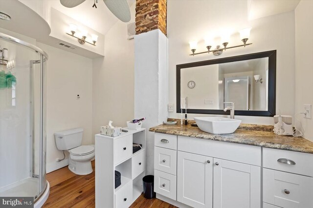 8954 Courthouse Rd, Spotsylvania, VA 22553 - bathroom featuring wood finished floors, a stall shower, vanity, and toilet