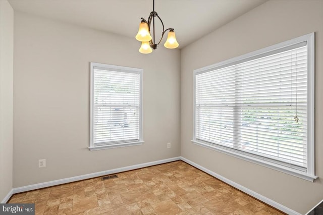 35367 Pheasant Ridge Rd, Locust Grove, VA 22508 - unfurnished room with a chandelier, healthy amount of natural light, and stone finish flooring