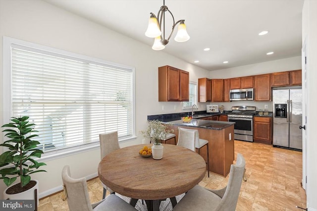 35367 Pheasant Ridge Rd, Locust Grove, VA 22508 - kitchen with appliances with stainless steel finishes, dark countertops, a chandelier, brown cabinetry, and a peninsula