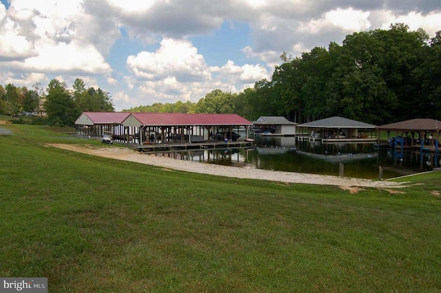 dock featuring a lawn and a water view