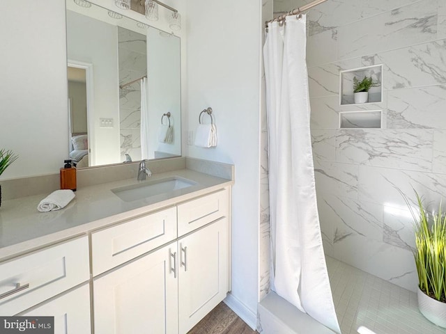 bathroom with curtained shower and vanity