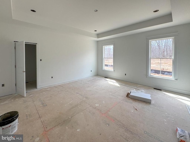 spare room featuring a tray ceiling
